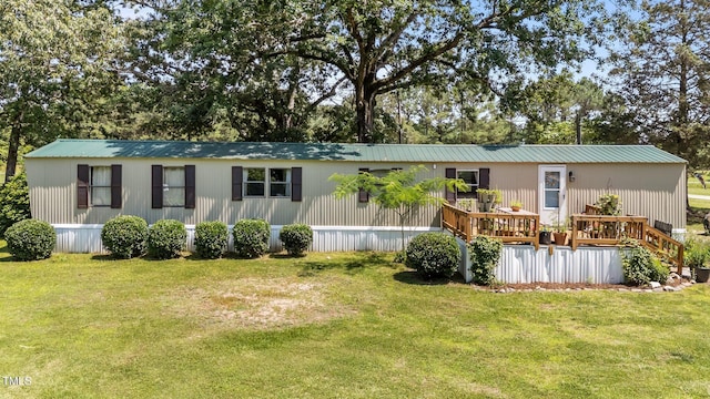 1355 Sykes Rd, Spring Hope, NC 27882 - view of front of property with a front lawn, a deck, and metal roof