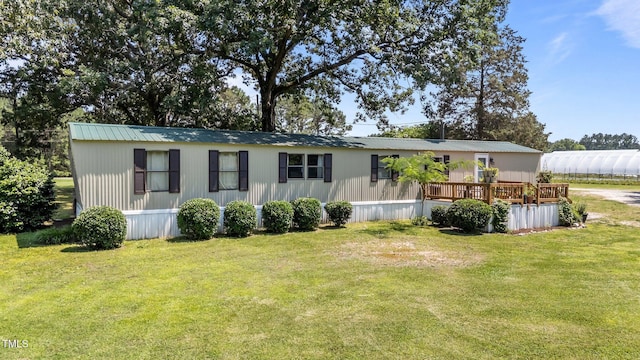 1355 Sykes Rd, Spring Hope, NC 27882 - view of front of house featuring a front yard, a deck, and metal roof