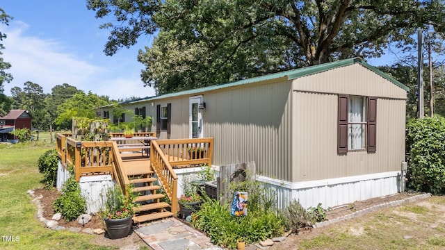 1355 Sykes Rd, Spring Hope, NC 27882 - manufactured / mobile home with a deck, a front lawn, and stairway