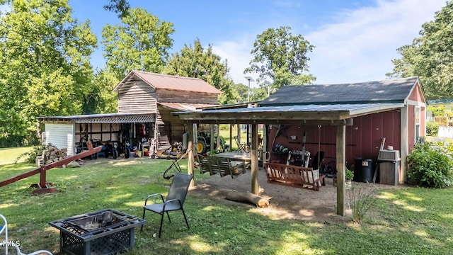 1355 Sykes Rd, Spring Hope, NC 27882 - back of house with a yard, an outdoor fire pit, and a pole building