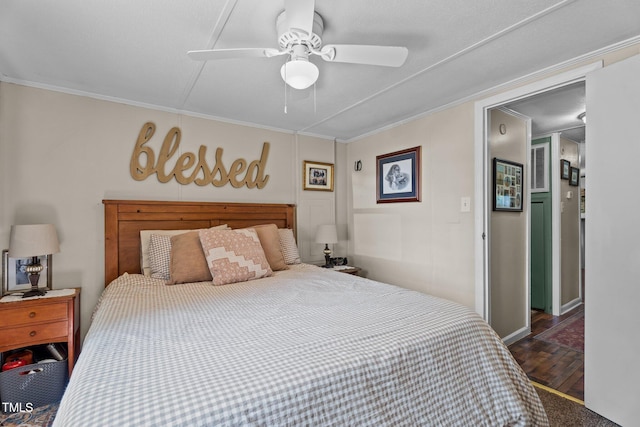 1355 Sykes Rd, Spring Hope, NC 27882 - bedroom with dark wood-type flooring, crown molding, and a ceiling fan