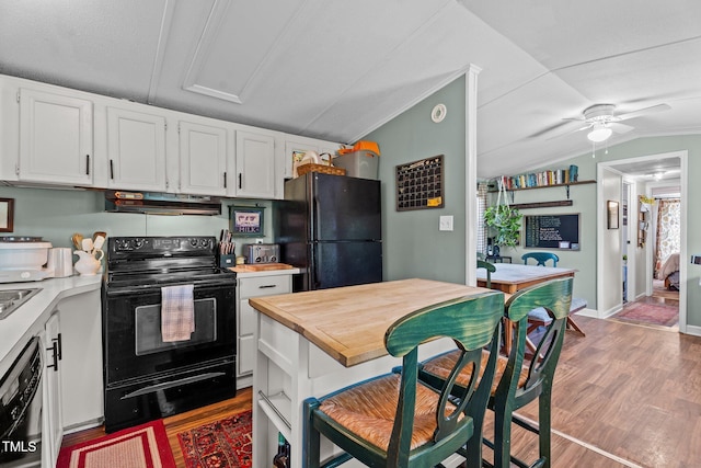 1355 Sykes Rd, Spring Hope, NC 27882 - kitchen with black appliances, range hood, vaulted ceiling, ceiling fan, and white cabinetry