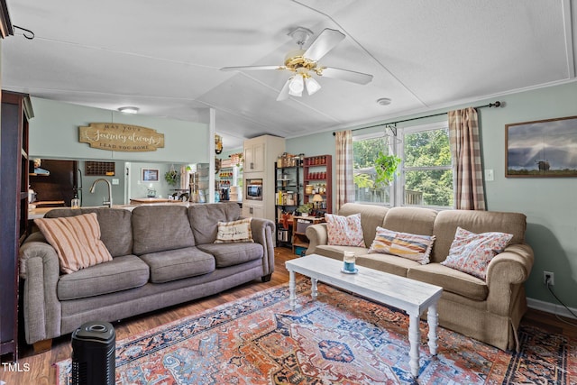 1355 Sykes Rd, Spring Hope, NC 27882 - living area featuring wood finished floors, a ceiling fan, and vaulted ceiling