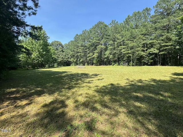 1355 Sykes Rd, Spring Hope, NC 27882 - view of green lawn featuring a wooded view