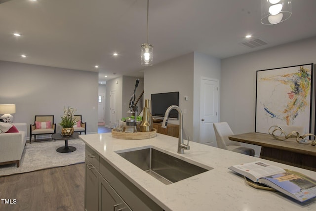 1227 Bessie Ct, Wake Forest, NC 27587 - kitchen with a sink, open floor plan, dark wood-style floors, light stone counters, and gray cabinets