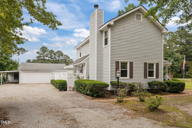 2000 Glissom St, Tarboro, NC 27886 - view of side of home featuring a chimney, a garage, and driveway