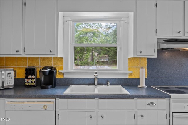 2000 Glissom St, Tarboro, NC 27886 - kitchen with range hood, white appliances, dark countertops, white cabinets, and backsplash