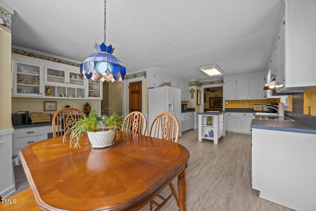 2000 Glissom St, Tarboro, NC 27886 - dining room featuring light wood finished floors and a textured ceiling