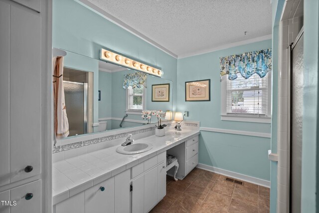 2000 Glissom St, Tarboro, NC 27886 - bathroom featuring healthy amount of natural light, vanity, a textured ceiling, a shower stall, and ornamental molding