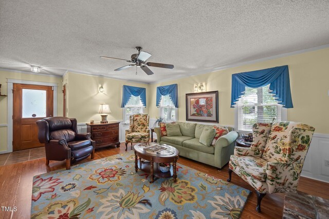2000 Glissom St, Tarboro, NC 27886 - living area featuring plenty of natural light, a textured ceiling, ornamental molding, wood finished floors, and ceiling fan