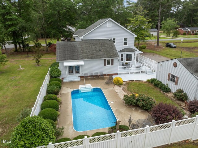 2000 Glissom St, Tarboro, NC 27886 - rear view of house featuring a shingled roof, a wooden deck, a fenced backyard, a patio area, and view of scattered trees