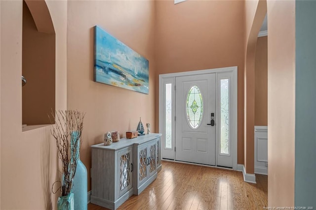 416 Kentucky Derby Ln, Lillington, NC 27546 - foyer with arched walkways, hardwood / wood-style flooring, a towering ceiling, and baseboards
