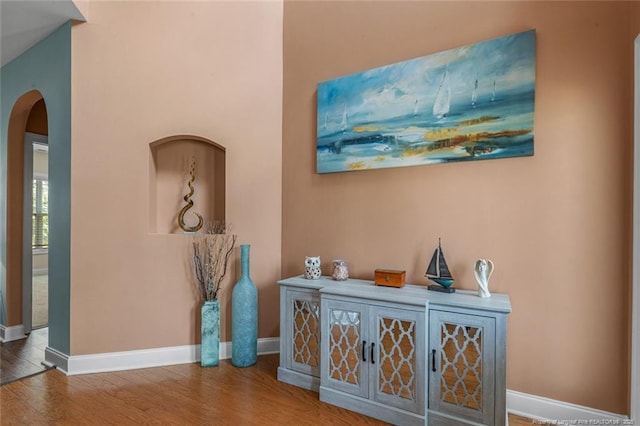 416 Kentucky Derby Ln, Lillington, NC 27546 - hallway with arched walkways, wood finished floors, and baseboards