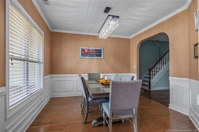 416 Kentucky Derby Ln, Lillington, NC 27546 - dining area with wood finished floors, crown molding, arched walkways, a wainscoted wall, and stairway