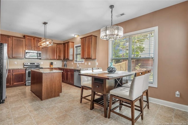 416 Kentucky Derby Ln, Lillington, NC 27546 - kitchen with stainless steel appliances, a chandelier, healthy amount of natural light, and tasteful backsplash