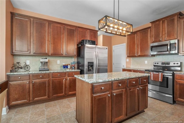416 Kentucky Derby Ln, Lillington, NC 27546 - kitchen with appliances with stainless steel finishes, backsplash, light stone countertops, and a center island