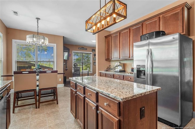 416 Kentucky Derby Ln, Lillington, NC 27546 - kitchen featuring stainless steel fridge with ice dispenser, a chandelier, light stone counters, a kitchen island, and decorative light fixtures