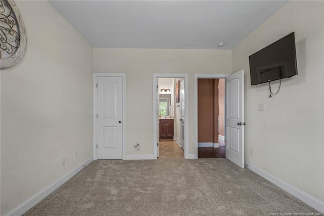 416 Kentucky Derby Ln, Lillington, NC 27546 - unfurnished bedroom with carpet, baseboards, and ensuite bathroom