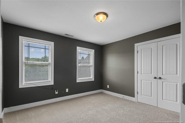 416 Kentucky Derby Ln, Lillington, NC 27546 - unfurnished bedroom with light colored carpet, baseboards, and a closet