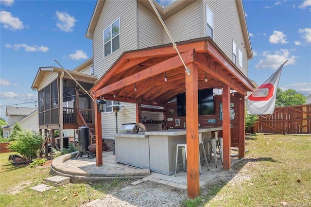 416 Kentucky Derby Ln, Lillington, NC 27546 - rear view of house with a sunroom, a patio area, and area for grilling