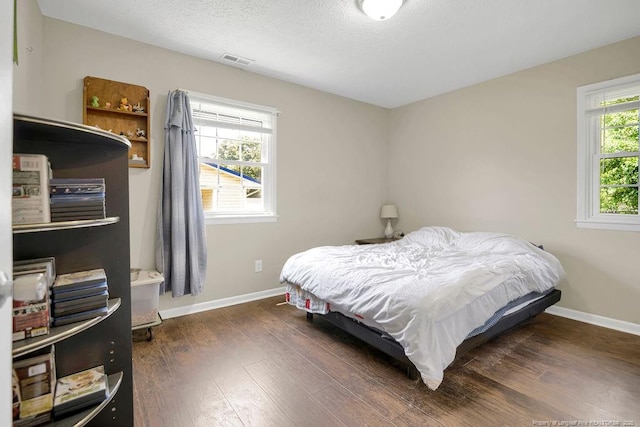 6582 Vineyard Dr, Fayetteville, NC 28304 - bedroom featuring wood finished floors, baseboards, and a textured ceiling