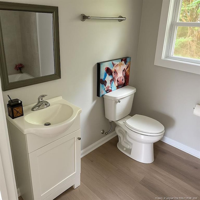 432 Squirrel St, Fayetteville, NC 28303 - bathroom featuring baseboards, vanity, toilet, and wood finished floors