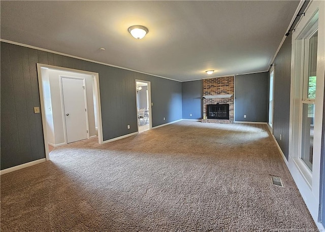 918 Dandridge Dr, Fayetteville, NC 28303 - unfurnished living room with ornamental molding, carpet flooring, a brick fireplace, and baseboards
