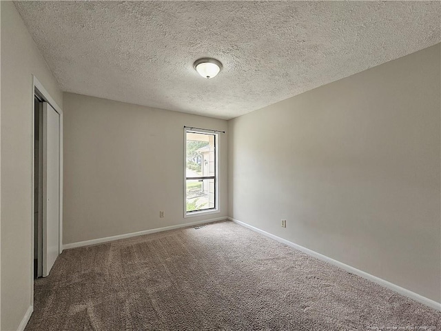 918 Dandridge Dr, Fayetteville, NC 28303 - unfurnished bedroom featuring carpet floors, a textured ceiling, baseboards, and a closet