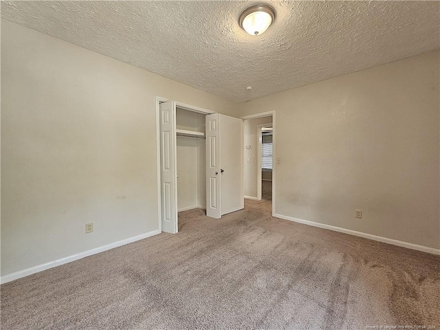 918 Dandridge Dr, Fayetteville, NC 28303 - unfurnished bedroom with carpet flooring, a textured ceiling, a closet, and baseboards