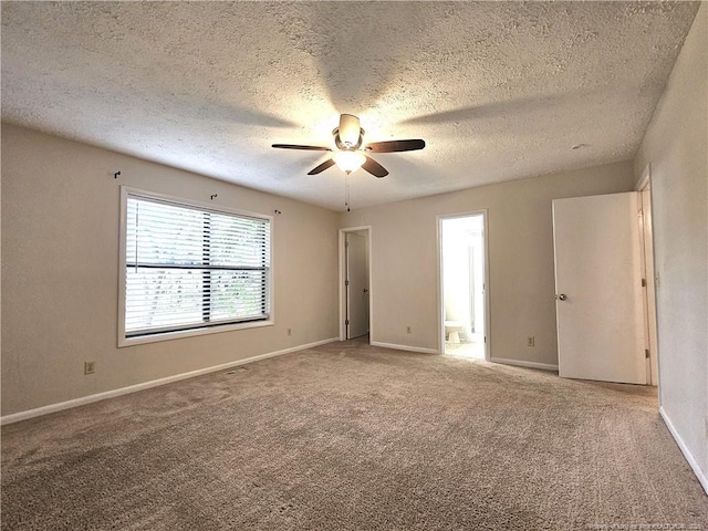 918 Dandridge Dr, Fayetteville, NC 28303 - unfurnished bedroom with carpet, a textured ceiling, connected bathroom, baseboards, and ceiling fan