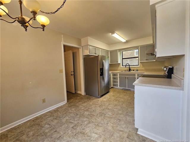 918 Dandridge Dr, Fayetteville, NC 28303 - kitchen featuring stainless steel fridge with ice dispenser, range with electric cooktop, a chandelier, a sink, and light countertops