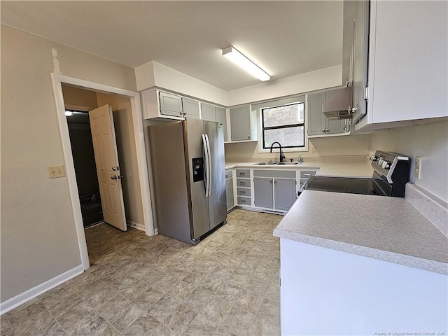 918 Dandridge Dr, Fayetteville, NC 28303 - kitchen with stainless steel appliances, a sink, light countertops, ventilation hood, and gray cabinetry