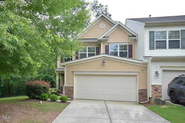 321 Westgrove Ct, Durham, NC 27703 - view of front facade featuring stone siding, driveway, and an attached garage