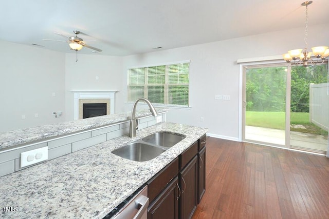 321 Westgrove Ct, Durham, NC 27703 - kitchen with a chandelier, a fireplace, dark brown cabinets, pendant lighting, and ceiling fan