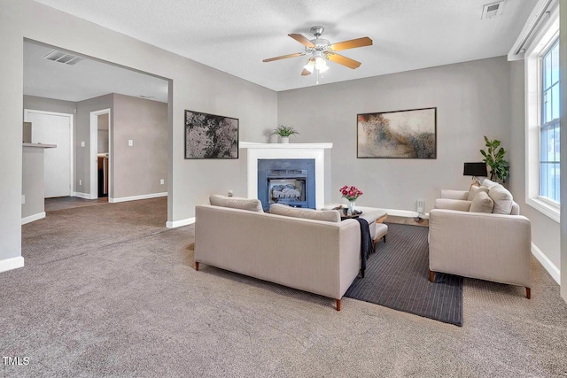 5617 Tealbrook Dr, Raleigh, NC 27610 - living room featuring carpet floors, a fireplace, and a ceiling fan