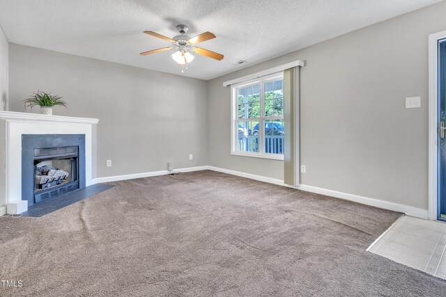5617 Tealbrook Dr, Raleigh, NC 27610 - unfurnished living room with ceiling fan, carpet flooring, a fireplace with flush hearth, and a textured ceiling