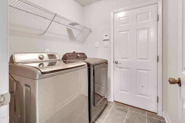 5617 Tealbrook Dr, Raleigh, NC 27610 - washroom featuring washer and clothes dryer and light tile patterned flooring