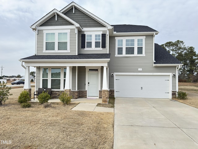 13 Knotty Pine Ln, Clayton, NC 27520 - craftsman house with a porch, driveway, an attached garage, a shingled roof, and stone siding