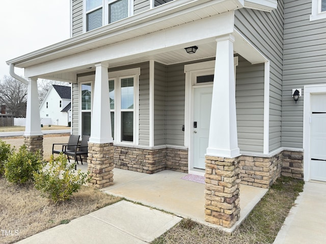 13 Knotty Pine Ln, Clayton, NC 27520 - view of exterior entry featuring covered porch and stone siding