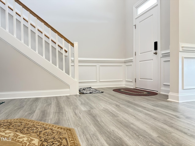 13 Knotty Pine Ln, Clayton, NC 27520 - entryway with a decorative wall, wood finished floors, wainscoting, and stairway