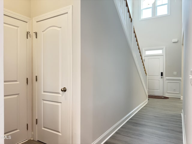13 Knotty Pine Ln, Clayton, NC 27520 - hallway with stairway, a high ceiling, baseboards, and dark wood-style flooring