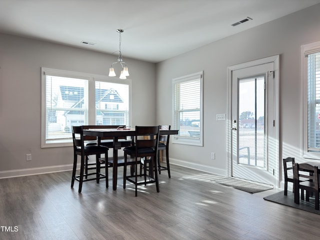13 Knotty Pine Ln, Clayton, NC 27520 - dining room featuring dark wood-style flooring, baseboards, and a chandelier