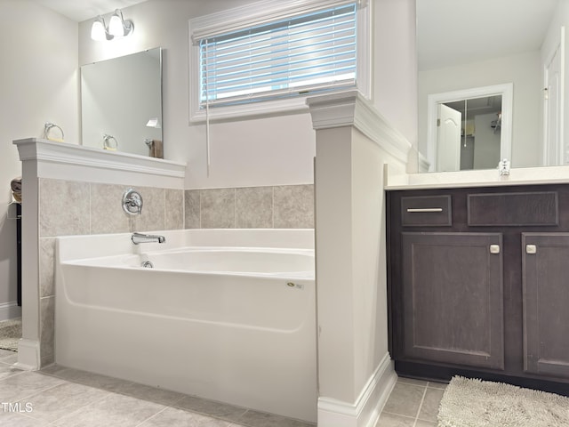 13 Knotty Pine Ln, Clayton, NC 27520 - bathroom featuring a garden tub, tile patterned floors, vanity, and baseboards
