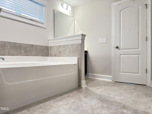 13 Knotty Pine Ln, Clayton, NC 27520 - bathroom featuring a garden tub, vanity, baseboards, and tile patterned floors