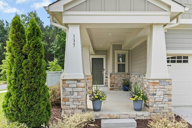 137 Azalea View Way, Holly Springs, NC 27540 - view of exterior entry with board and batten siding, stone siding, and an attached garage