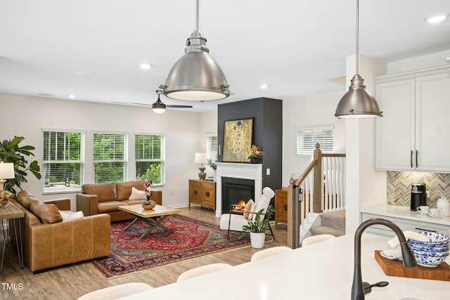 137 Azalea View Way, Holly Springs, NC 27540 - living area with light wood-type flooring, a glass covered fireplace, recessed lighting, and ceiling fan
