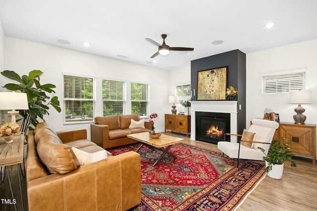 137 Azalea View Way, Holly Springs, NC 27540 - living room featuring wood finished floors, ceiling fan, a glass covered fireplace, and recessed lighting