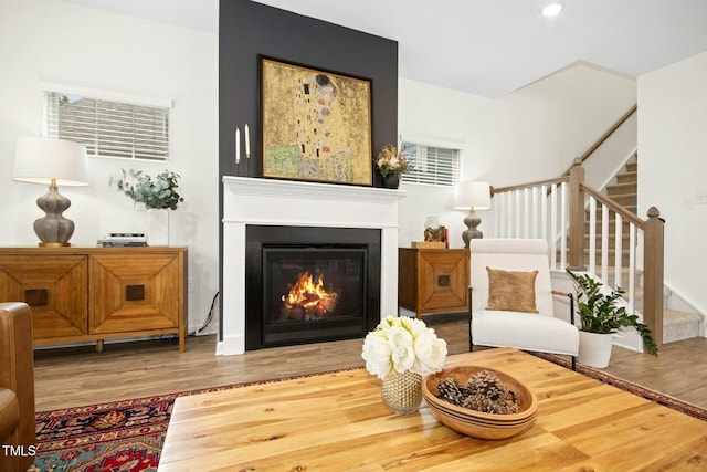137 Azalea View Way, Holly Springs, NC 27540 - living area featuring wood finished floors, stairs, a lit fireplace, and recessed lighting