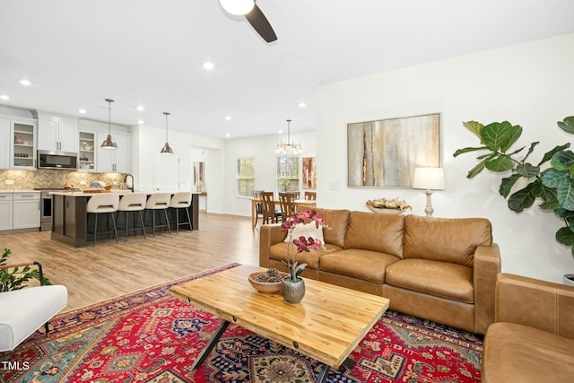 137 Azalea View Way, Holly Springs, NC 27540 - living room with light wood-style flooring, ceiling fan, recessed lighting, and a chandelier
