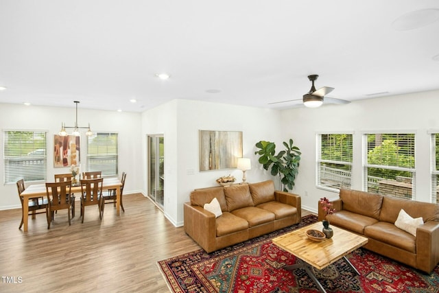 137 Azalea View Way, Holly Springs, NC 27540 - living room with healthy amount of natural light, wood finished floors, ceiling fan, recessed lighting, and a chandelier